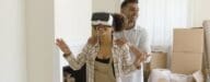 a couple walks through their house with VR goggles to see virtual staging