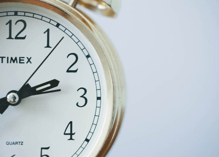 close up of half an analog clock representing time savers when selling a house on a budget