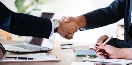 an illustration of an agent closing a deal with a client
