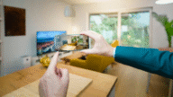 A person photographing a living room for a virtual real estate tour.