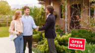 A photo of a real estate agent hosting an open house.