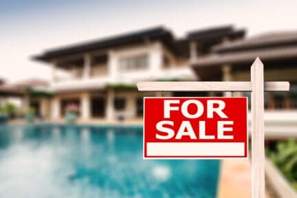 A for-sale sign in front of a house