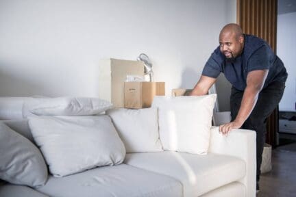 A man moving out of a house.