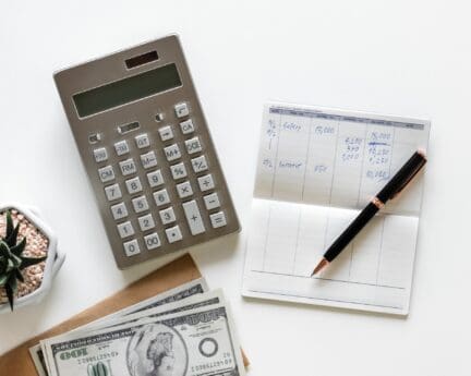 Calculator and financial log used to figure out moving expenses.