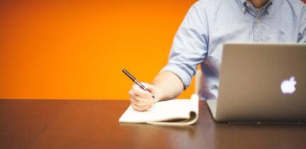 Man adding moving insurance to a to-do list.