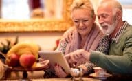 A couple looking at a table while downsizing their home for retirement.