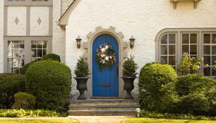 A front door are that has been cleaned and staged outside of a house.