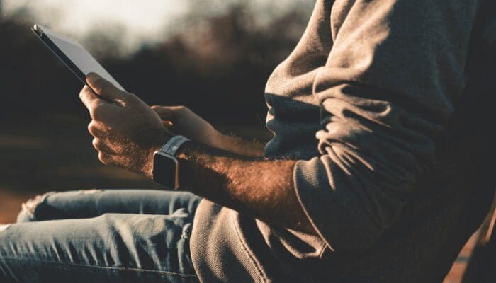 A man reading a real estate ad on an ipad.