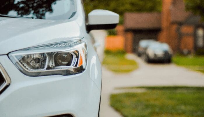 A car at an open house with etiquette for sellers.