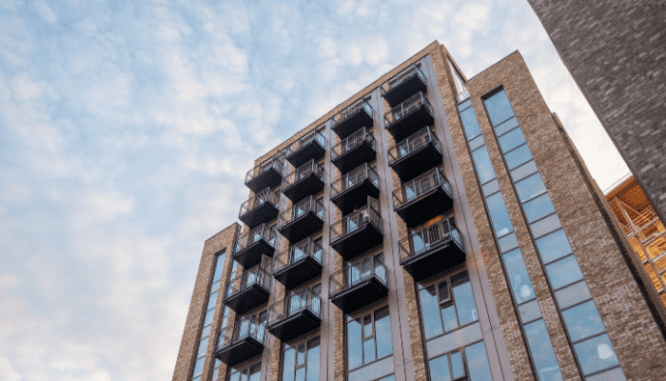 An apartment building used to rent vs buy a home.