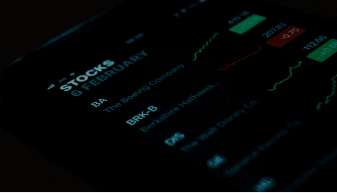 A screen showing stocks, which could predict a housing market recession.