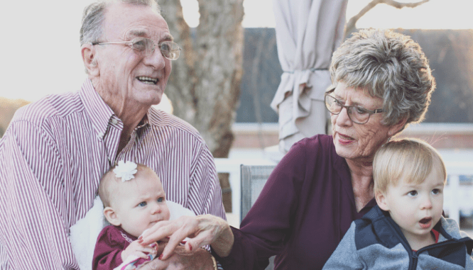 A senior couple with their grandchildren.