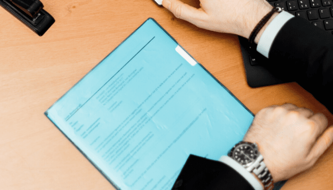 Hands over an appraisal contract.