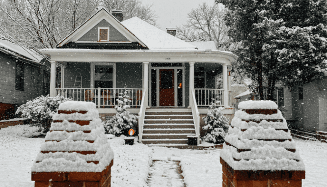 A bungalow home with curb appeal during a snowy day.