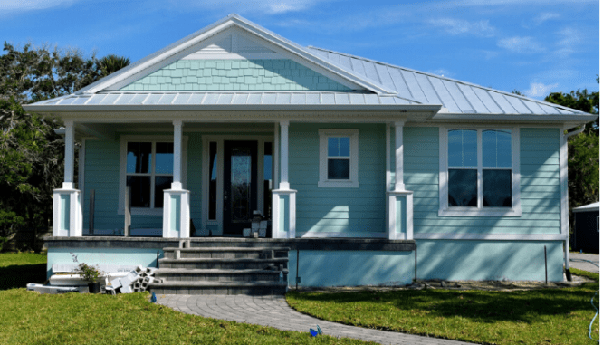 A blue bungalow house with curb appeal.