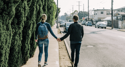 A couple walking away from a house purchase.