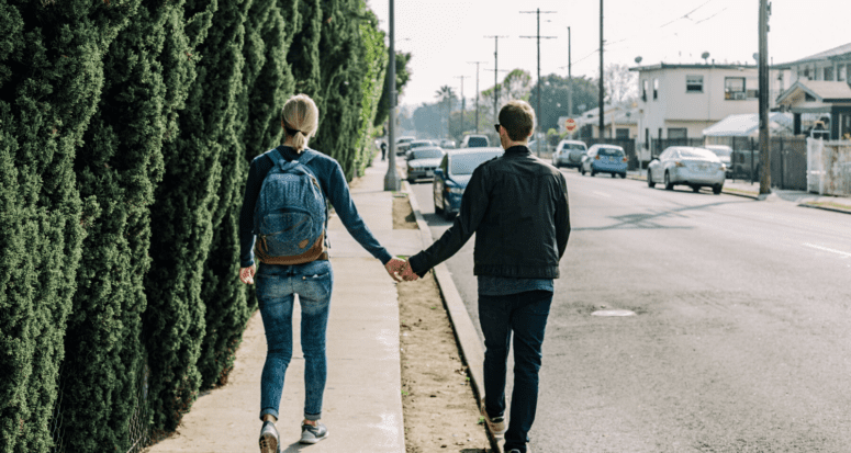 A couple walking away from a house purchase.