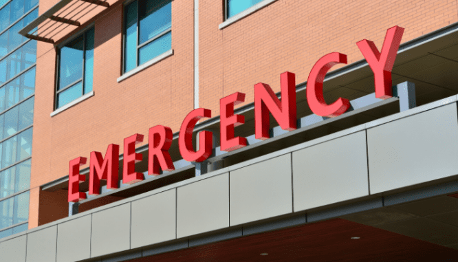 A view of the emergency sign above a hospital emergency room.