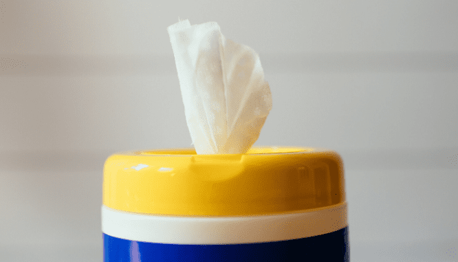 The top of a plastic container with sanitizer wipes in it.