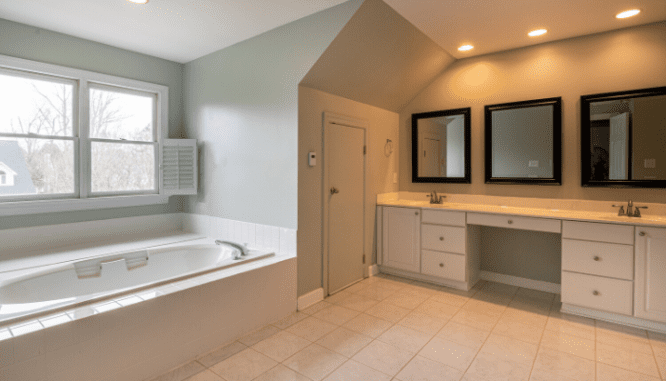 A master bathroom with two vanities and a Jacuzzi tub.