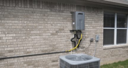 A tankless water heater attached to a house.
