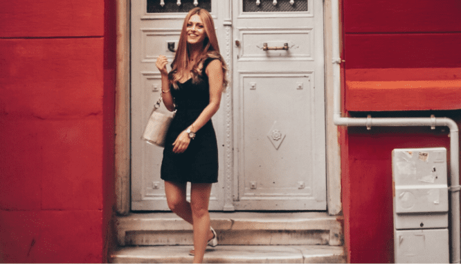 A woman in a black dress leaving her rent to own home.