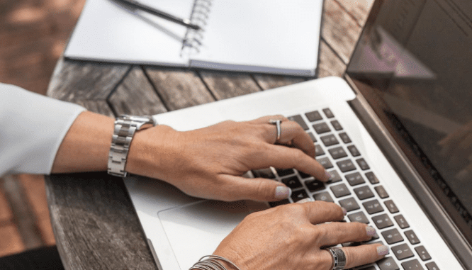 A photo shows a person typing to represent the preparation of flood disclosures.