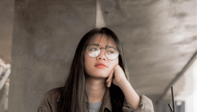 A woman with glasses wondering what under contract means.