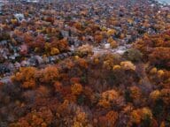 Aerial view of a suburban area with fall foliage