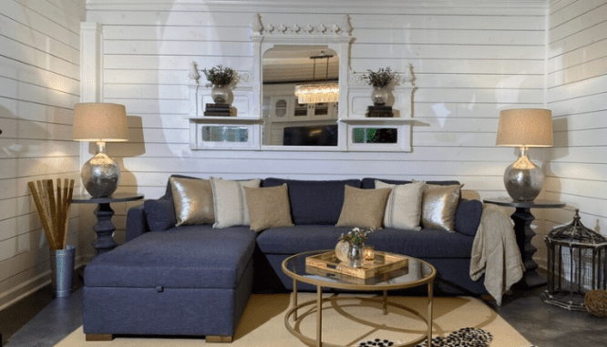 A couch in a basement designed to be a living room.