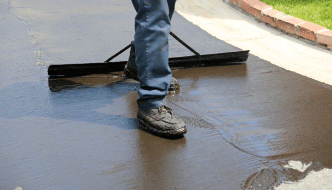 A person paving a driveway to add value to a home.