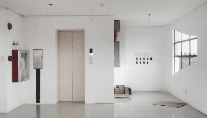 An elevator in an apartment you can buy in a city.