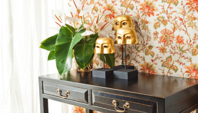 A table and decor used to stage a house with wallpaper.