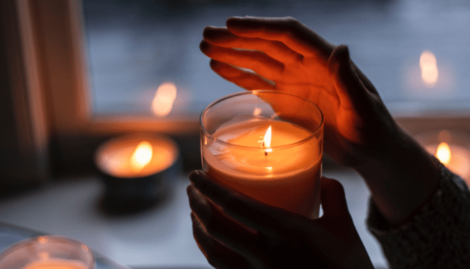 A candle inside a happy home.