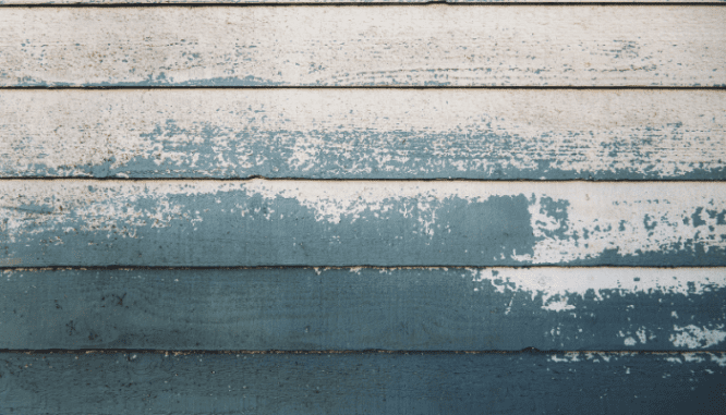 A wall that's been painted outside a happy home.