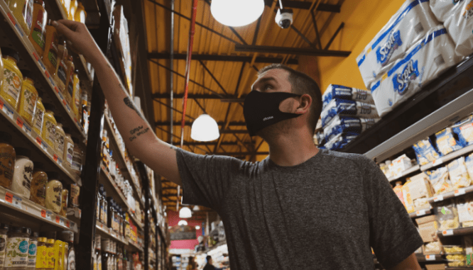 A person with a mask shopping in 2021.