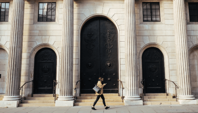 A person walking and a reading about down payment assistance.