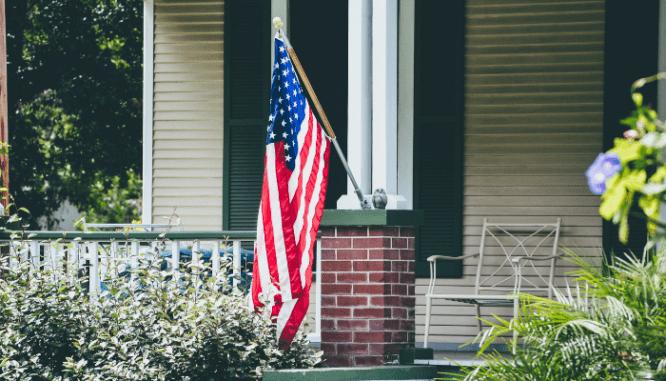 An American flag outside a house with a VA loan.