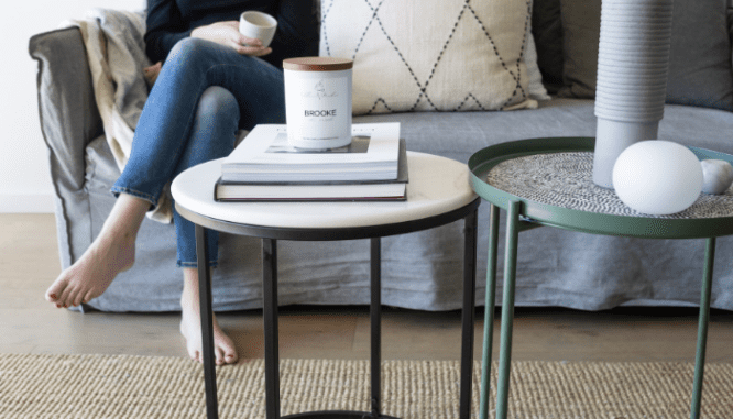 A person sitting on a couch in a rent to own home.