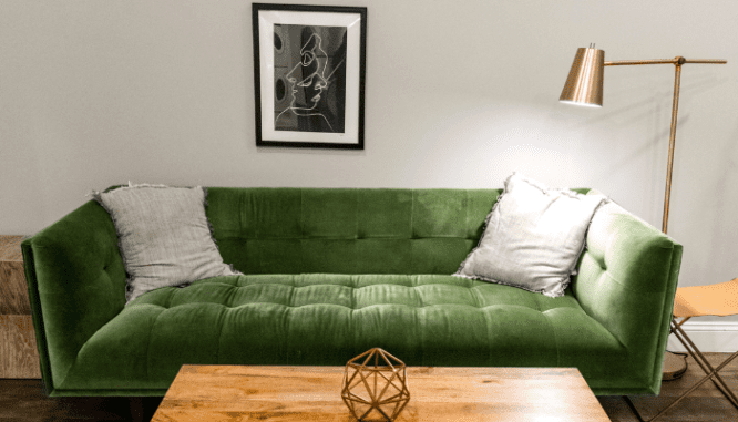 A couch in a living room with art deco interior design.