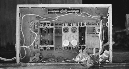 A picture of an old fuse box in a house for sale.