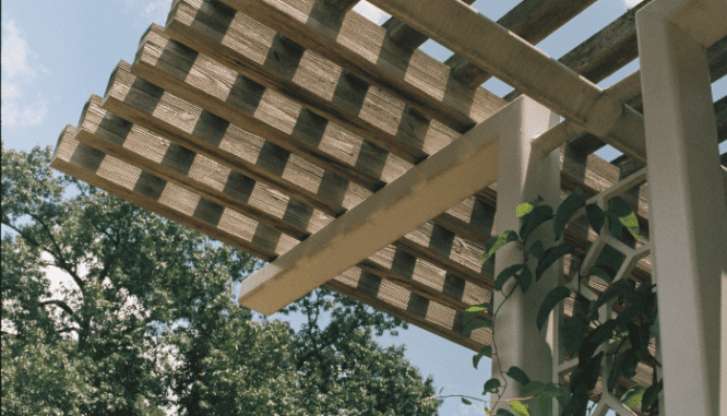 A pergola on a deck that was recently built.