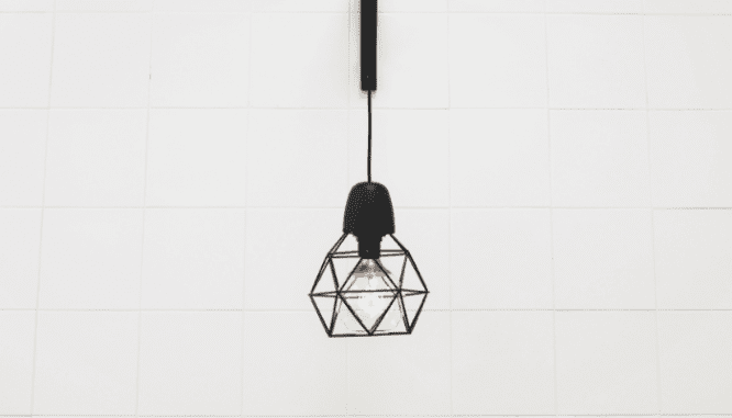 A hanging light fixture used in an open floor plan.