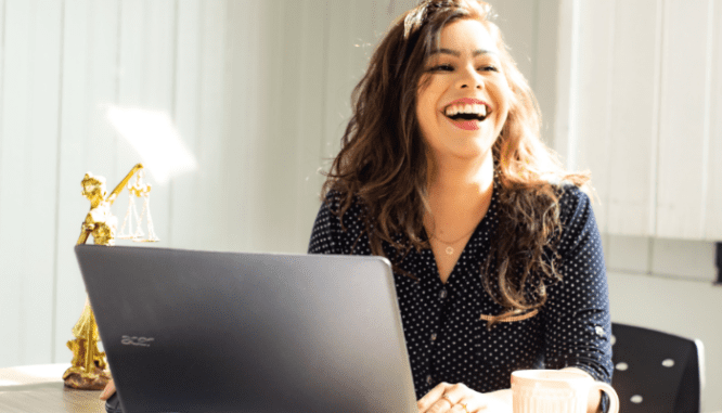 A woman looking at a residential appraisal on a laptop.