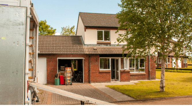 Exterior of house with moving van in front of it