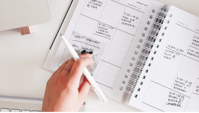 A person using a planner to save on moving costs.