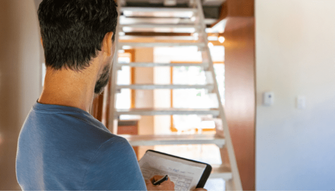 An inspector inspecting an unfinished basement.