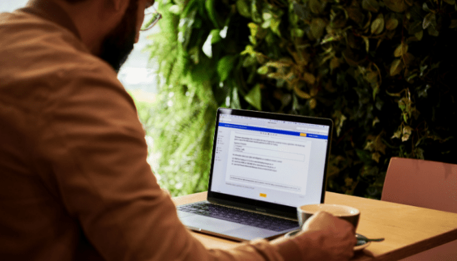 A condo owner reading FHA approval on a computer.