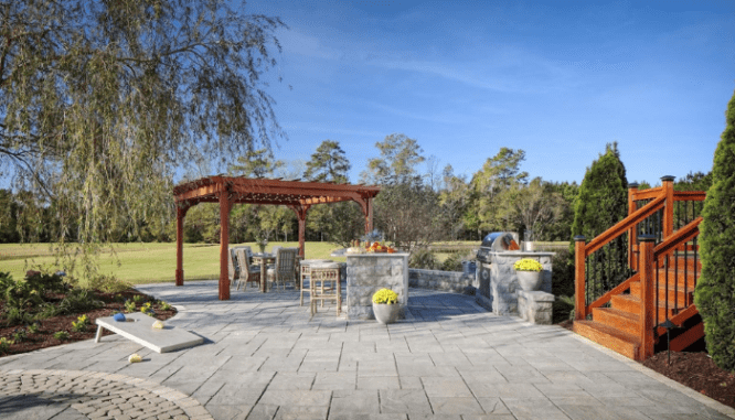 An outdoor kitchen with multiple areas for entertaining.