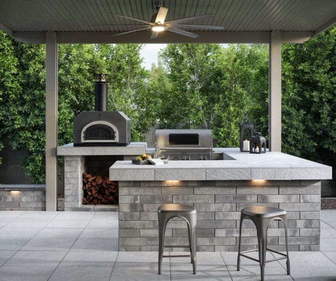 An outdoor kitchen with a wood-burning stove.